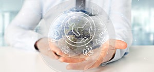 Businessman holding a World globe surronding by ecology icons an photo