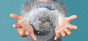 Businessman holding a World globe surronding by ecology icons an photo