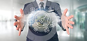 Businessman holding a World globe surronding by ecology icons an photo