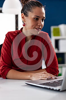 View of businesswoman typing on laptop and using touchped