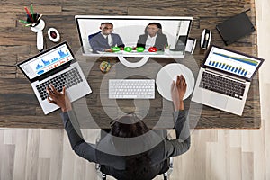 View Of Businesswoman Videoconferencing With Her Colleagues