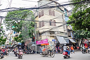 View of busy traffic with motorbikes and vehicles in Hanoi Old Quarter, capital of Vietnam.