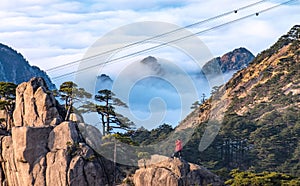 View of the cable car and photographer from the view point of the top of Huangshan Mountain or Yellow mountain in the winter