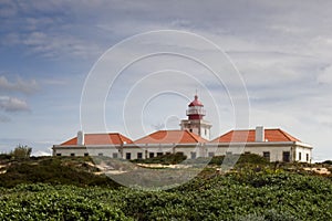 View of Cabo Sardao Lighthouse against the background of the cloudy sky. Odemira, Portugal. photo