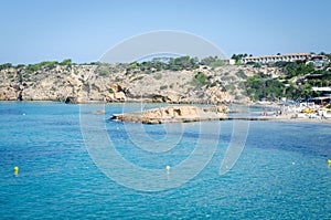 View of Cala Tarida with rocks in turquoise sea water, Ibiza island, Spain photo
