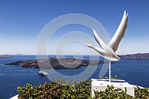 View of the caldera from the island of Santorini, cruise liner, bird sculpture,
