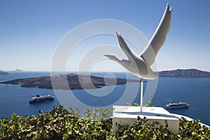 View of the caldera from the island of Santorini, cruise liners, bird sculpture,