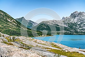 View at calm bay in Norway, between Nesna and Maela villages, blue water of Atlantic ocean, mountains, Calm sunny summer day