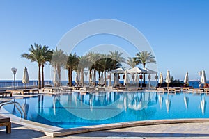 View on the calm deep blue water of the swimming pool with reflextion in Sharm El Sheikh resort