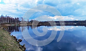 The view of the calm lake, the blue sky