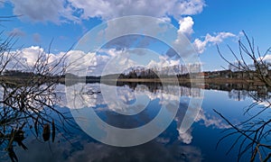 The view of the calm lake, the blue sky