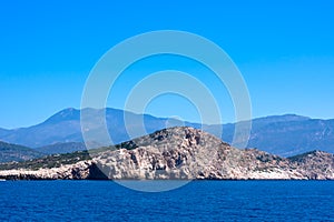 View of calm Mediterranean sea with  mountain, rocky islands.