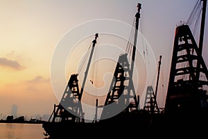 The view of the calm seascape in the shore under the colorful sunset.