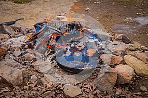 View of campfire with pan and poats in the fire, used for prepare the food and represent how the soldiers cooked in tha