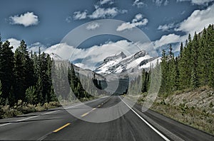 Road with a View of the Canadian Rockie mountains in Banff National Park in Alberta photo