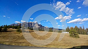 View of the Canadian Rockies from a driving car in Banff National Park, Alberta, Canada