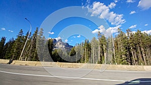 View of the Canadian Rockies from a driving car in Banff National Park, Alberta, Canada