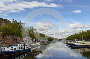 View of the canal with boats and beautiful buildings of Vlaardingen