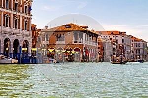 View of the canal with boats and gondolas in Venice, Italy. Venice is a popular tourist destination of Europe