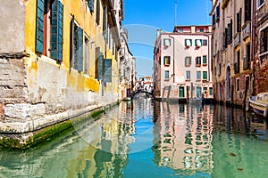 View of the canal with boats and gondolas in Venice, Italy. Venice is a popular tourist destination of Europe