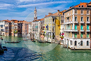 View of the canal with boats and gondolas in Venice, Italy. Venice is a popular tourist destination of Europe