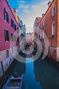 View of a Canal with boats and gondolas in Venice, Italy. Venice is a popular tourist destination of Europe.