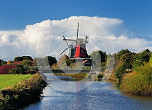 View From A Canal Bridge To The Famous Twin Mills Of Greetsiel East Frisia