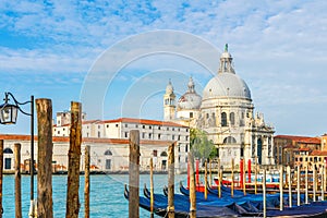 View of Canal Grande with historic Basilica di Santa Maria della Salute in the background and gondolas Venice, Italy