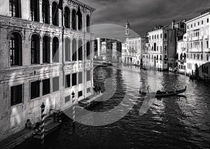 View of the canal from the Rialto Bridge in Venice. Boats and bridges. Veneto. Venice. Italy. Black and white