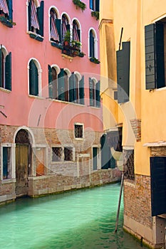 View of Canal in Venice with pink and yellow house