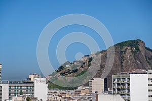 View of Cantagalo Hill, with its favela Pavao Pavaozinho, seen from rooftop of luxurious hotel in copacabana