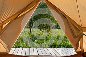 View from the canvas tent upon the green meadow