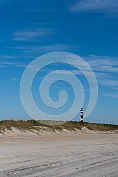 View of the Cape Lookout lighthouse from the beach in the Outer Banks of North Carolina