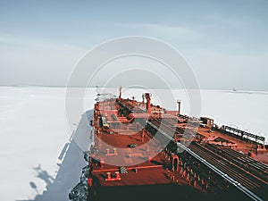 View from the captain\'s bridge to the deck of a large crude oil tanker sailing among the ice