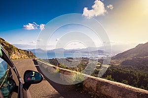 View from car at beautiful summer vacation landscape. Port, sea, mountains. Traveling photo