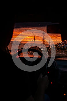 view from a car on the highway in bad weather conditions, rain and fog, at a beautiful red sunset