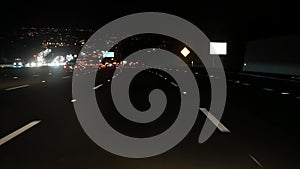 View from the car. Los Angeles busy freeway at night time. Massive Interstate Highway Road in California, USA. Auto