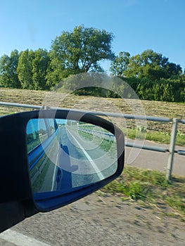 Traffic view of road in mirror while driving