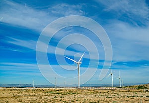 View from the car to a great wind turbines for produce electricity