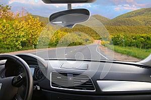 View from the car to the winding road in mountains