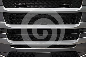 View on car truck cabin radiator cover with grid grille. Car radiator grille background pattern. Gray truck hood cabin front cover