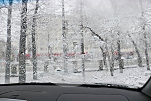 View from the car windscreen during rain and wet snow. Poor visibility while driving around the city.