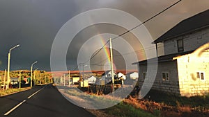 View through the car windshield of a double rainbow after rain