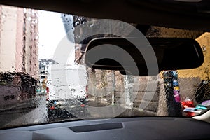 View through car windshield with rain drops on fall day in Paris