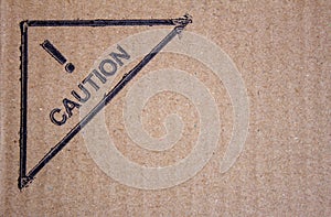 View of cardboard with caution sign. Package box with symbol cautioning fragile items and need careful handling
