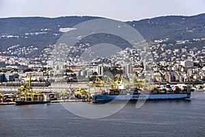 View of cargo ships docked at Pier VII of the Port of Trieste loading:unloading containers