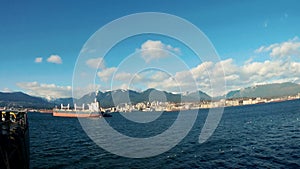 view from the cargo vessel on Vancouver port, cranes and The Lions peaks Mountains in summer time