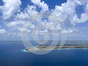 View of the Caribbean island of Bonaire from an airplane while landing blue water and blue sky