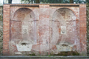 View of Carrara, Tuscany - Italy: the fountain of the big masks fontana dei mascheroni