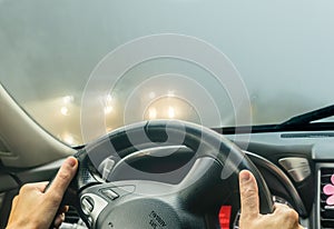 View through the cars windshield in the winter fog on the road